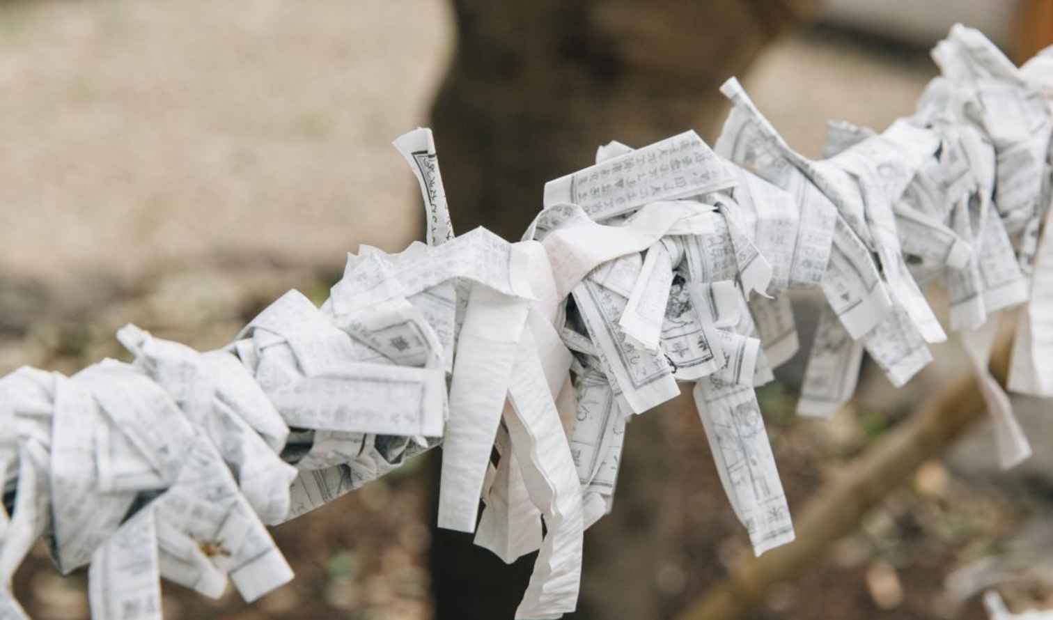 Omikuji papers tied on a string at a Japanese shrine in Kyoto