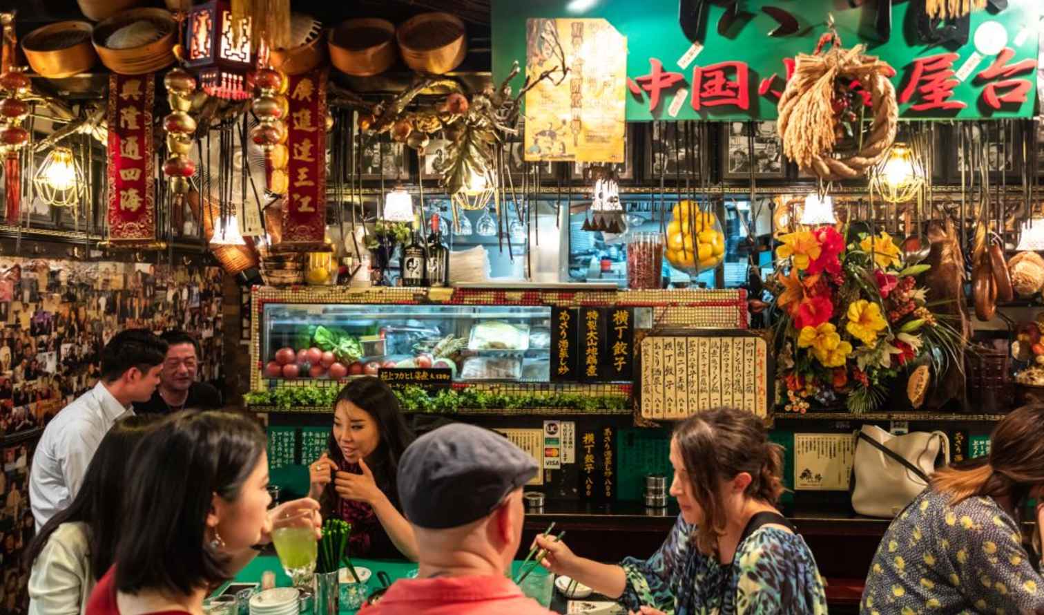Customers dine inside a Chinese restaurant in a busy urban area in Tokyo.