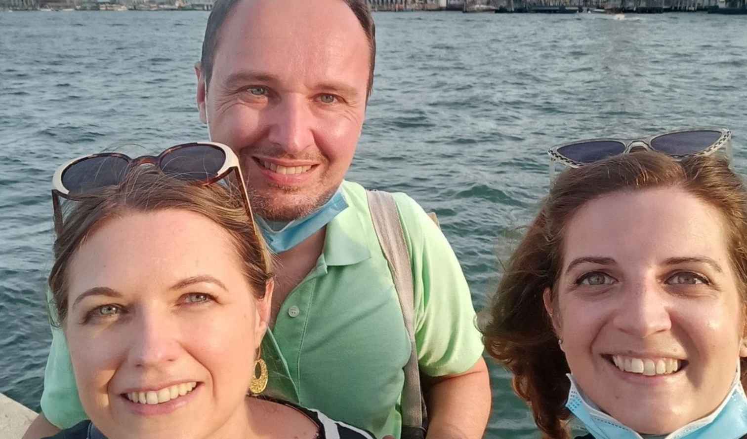 Three people taking a selfie with the Grand Canal in Venice behind them.