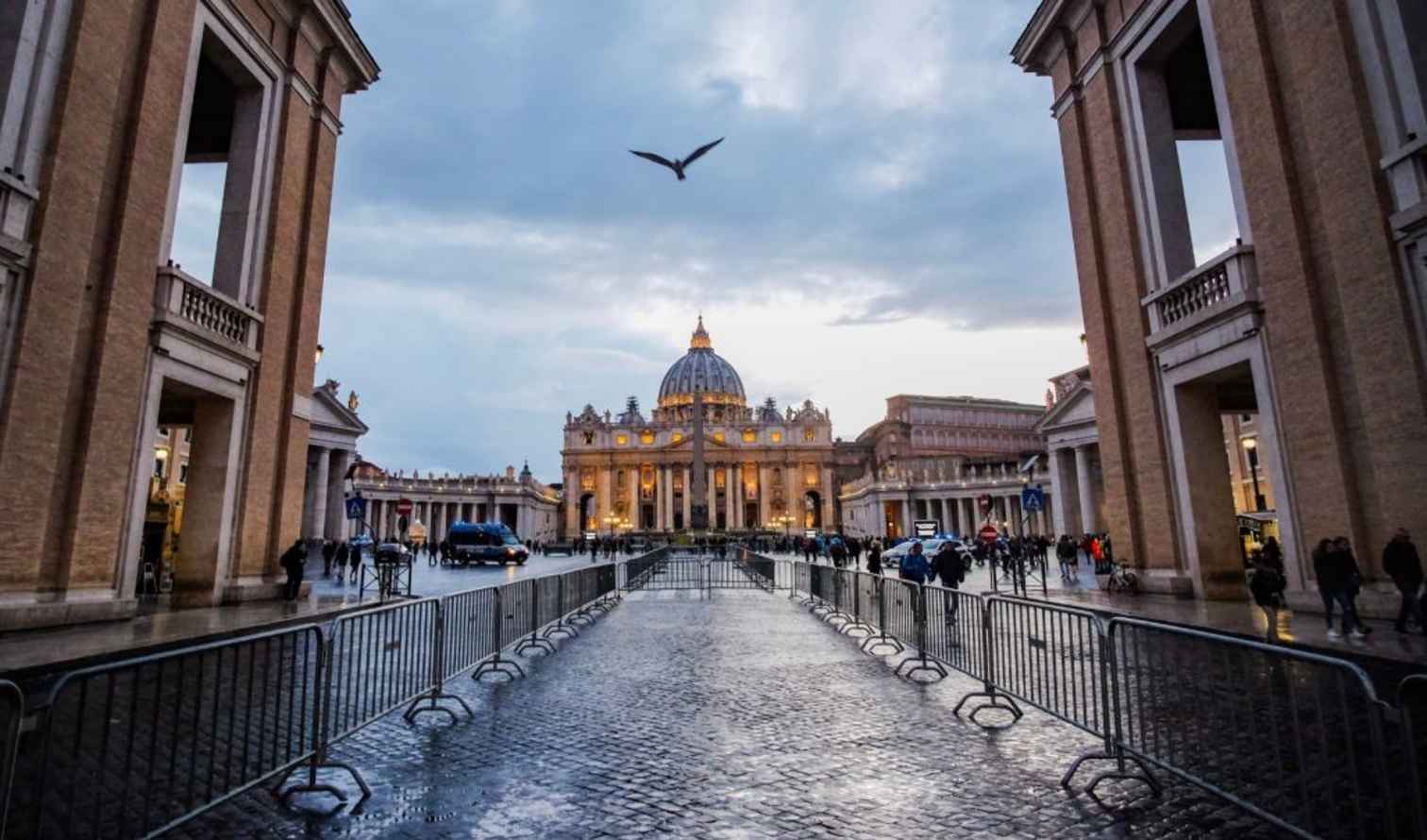 Crowd and security barriers at St. Peter's Square leading to the basilica.