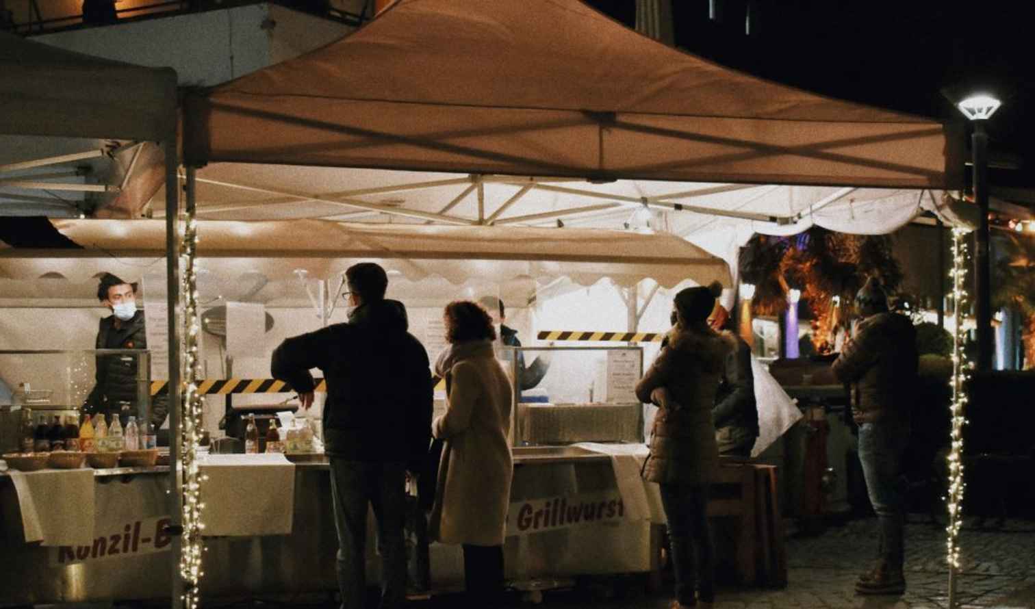 People lined up at a nighttime food stall  in Melbourne