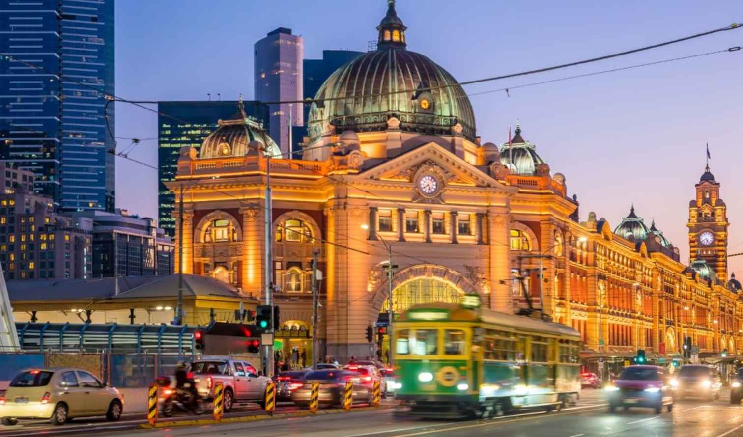 Flinders Street Station illuminated at twilight in Melbourne, Australia.