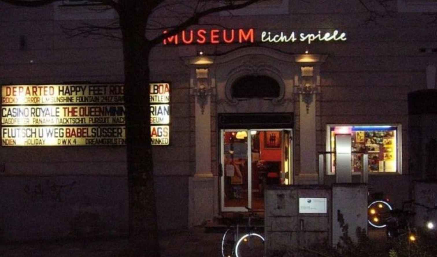 Front entrance of Museum Lichtspiele cinema in Munich at night.