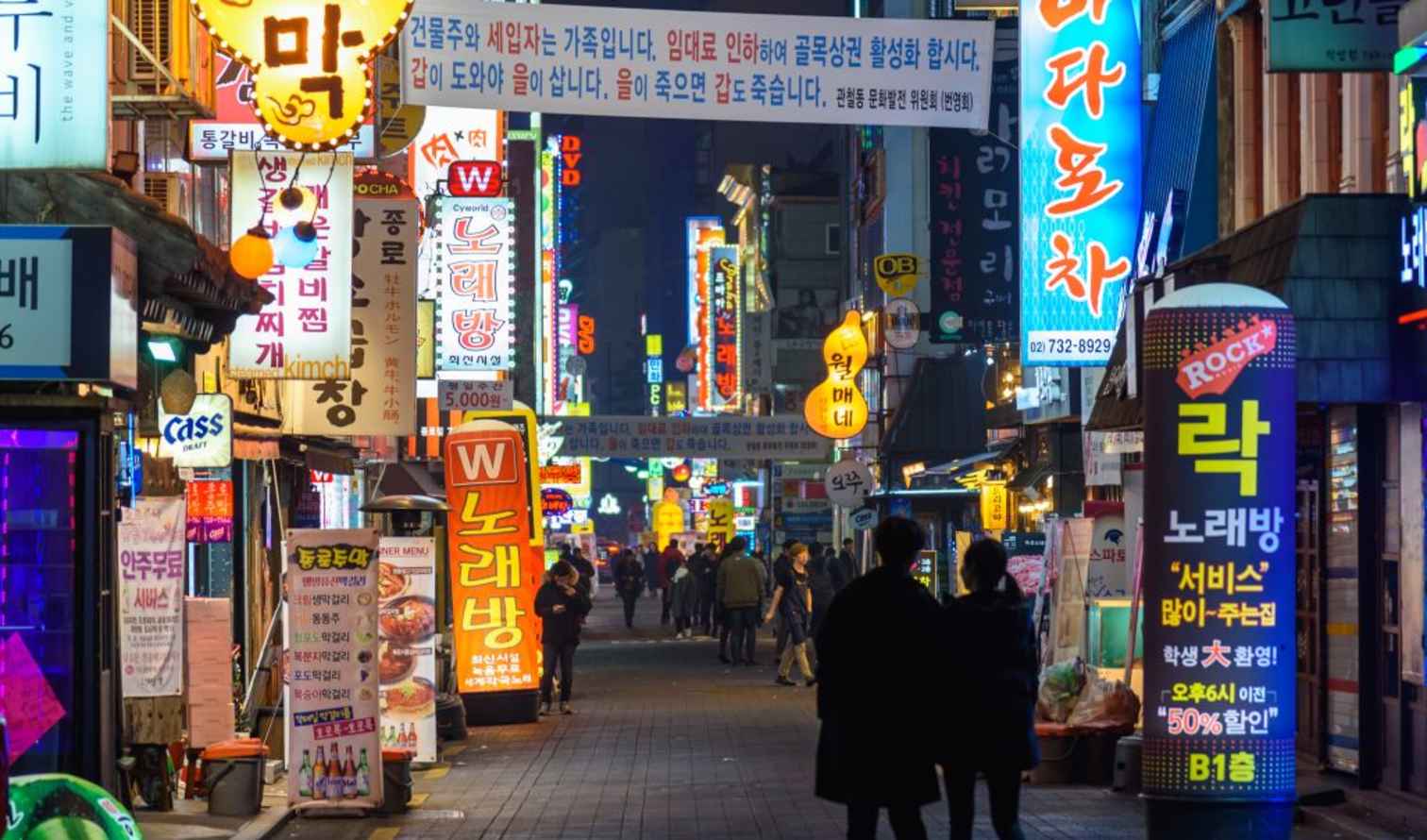 Outdoor view of bustling street with illuminated signs in Seoul