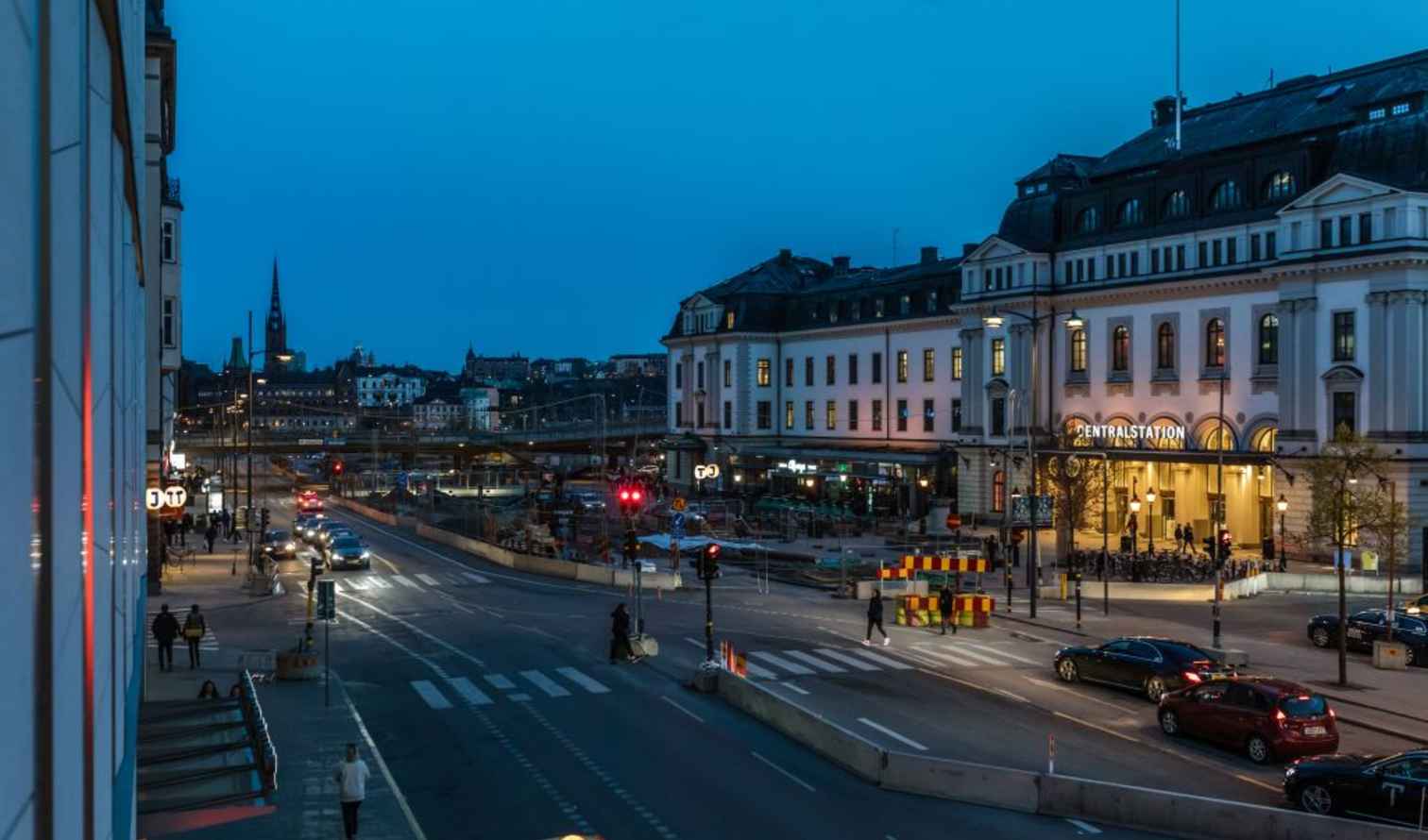 Facade of Stockholm Central Station with street visible at dusk.