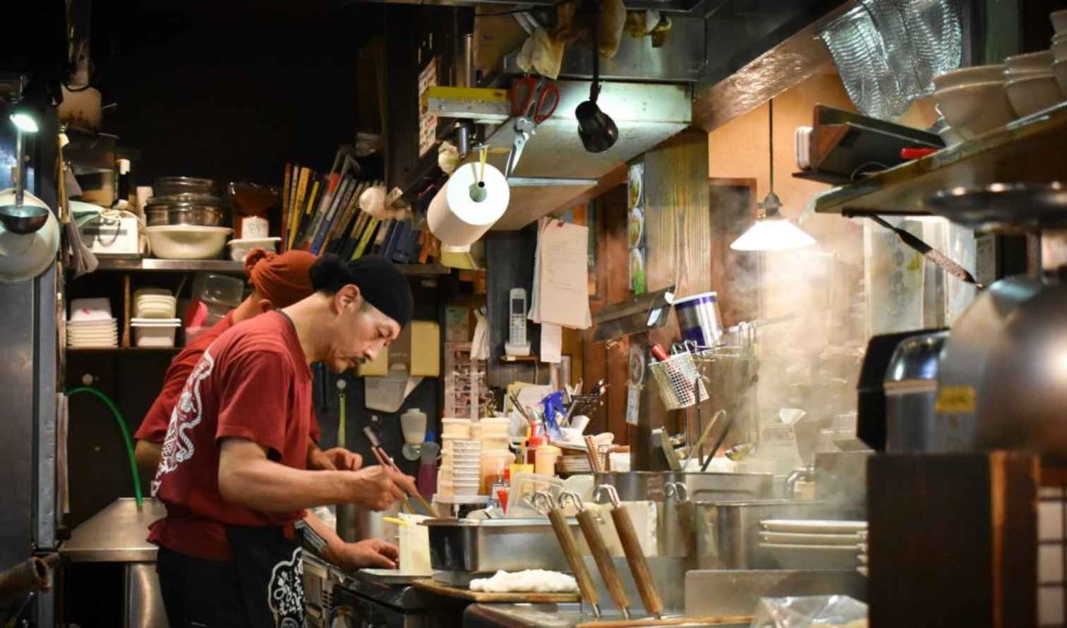 Chef preparing food in a Japanese ramen shop kitchen in Tokyo