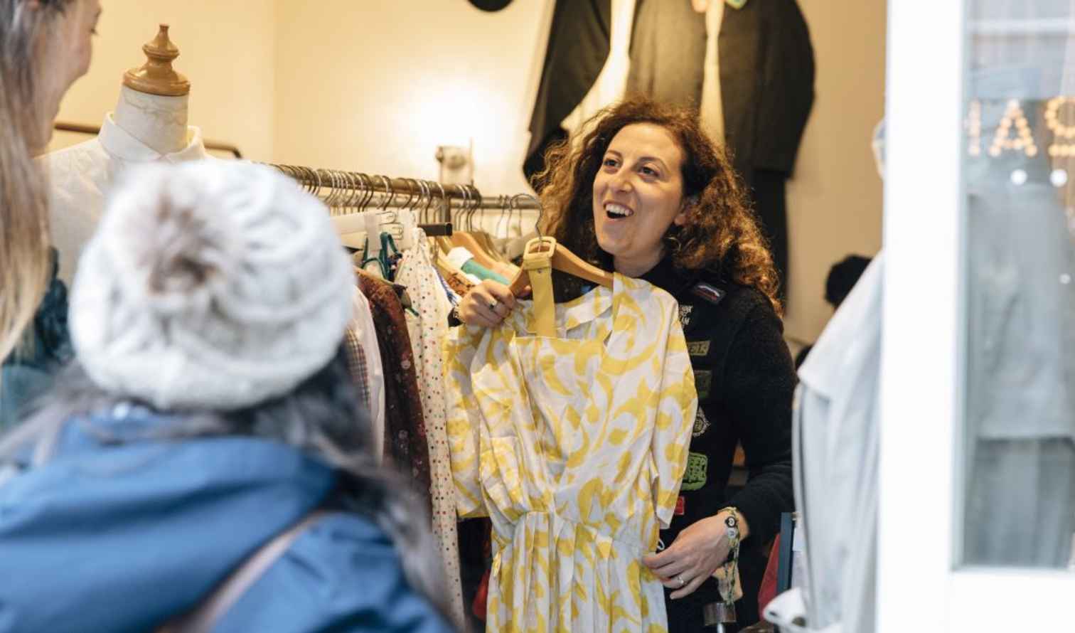 Person holding a yellow dress inside a clothing store in Tokyo