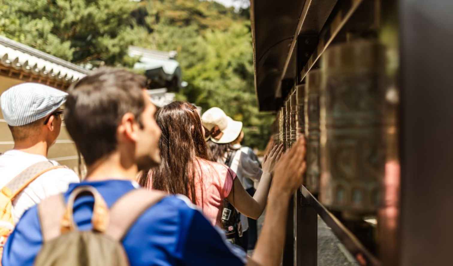 Visitors spin prayer wheels at a temple in Kyoto
