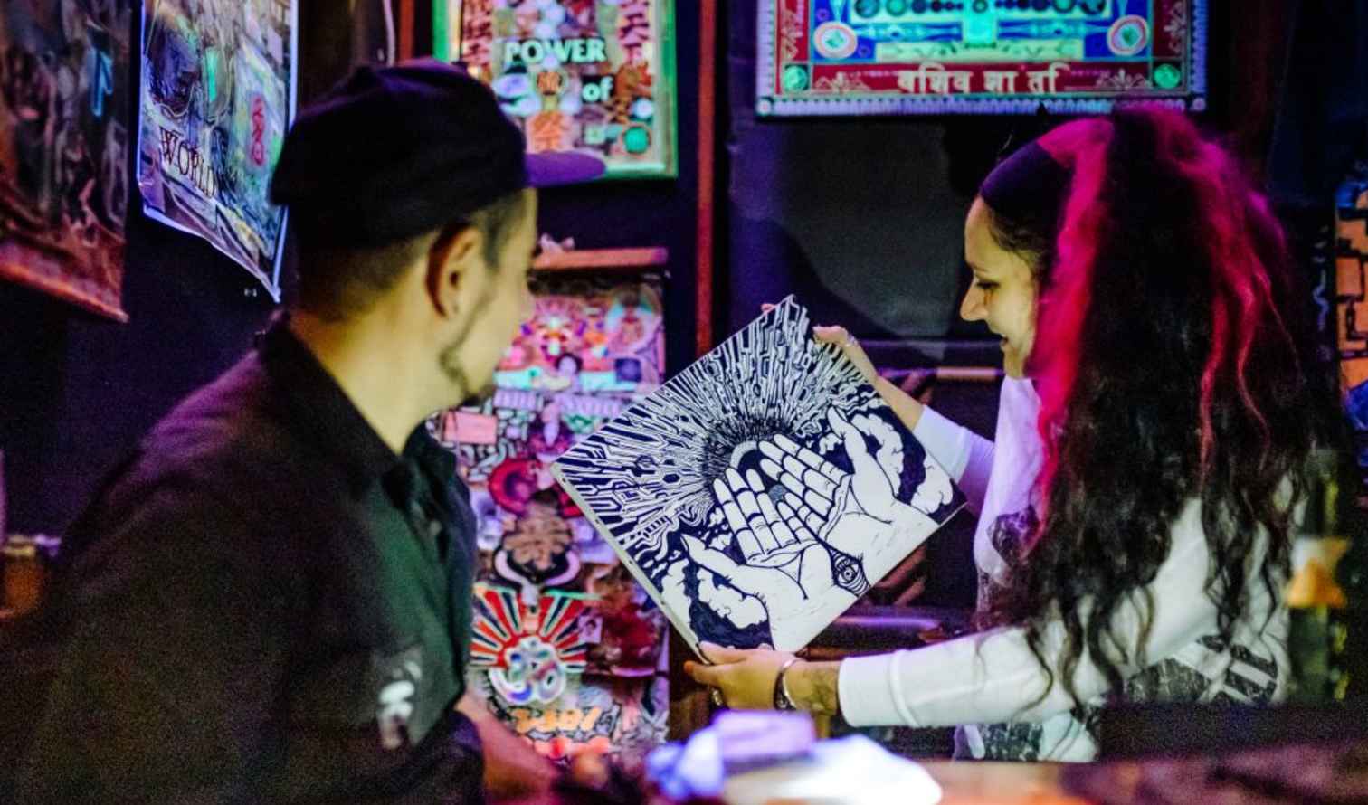 Two people looking at an art piece inside a shop in Osaka