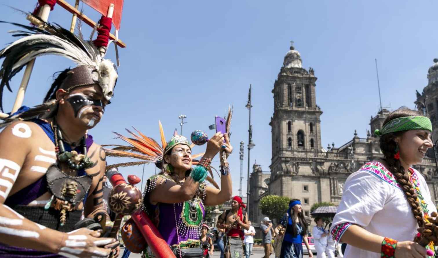 People in traditional costumes near Mexico City's Metropolitan Cathedral.