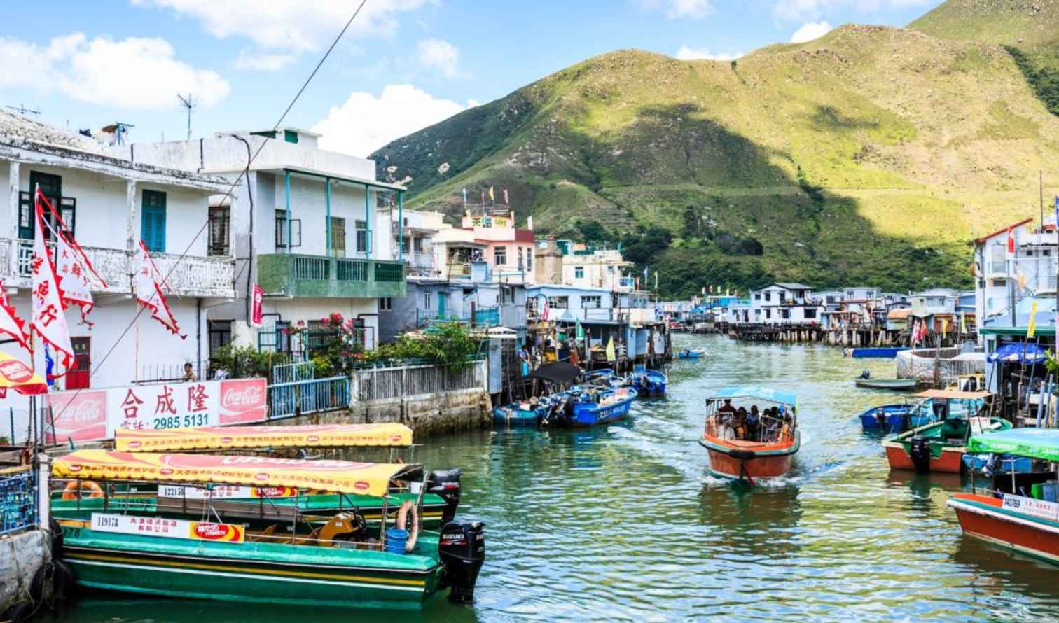Boats navigate a canal in Tai O, Lantau Island, Hong Kong.