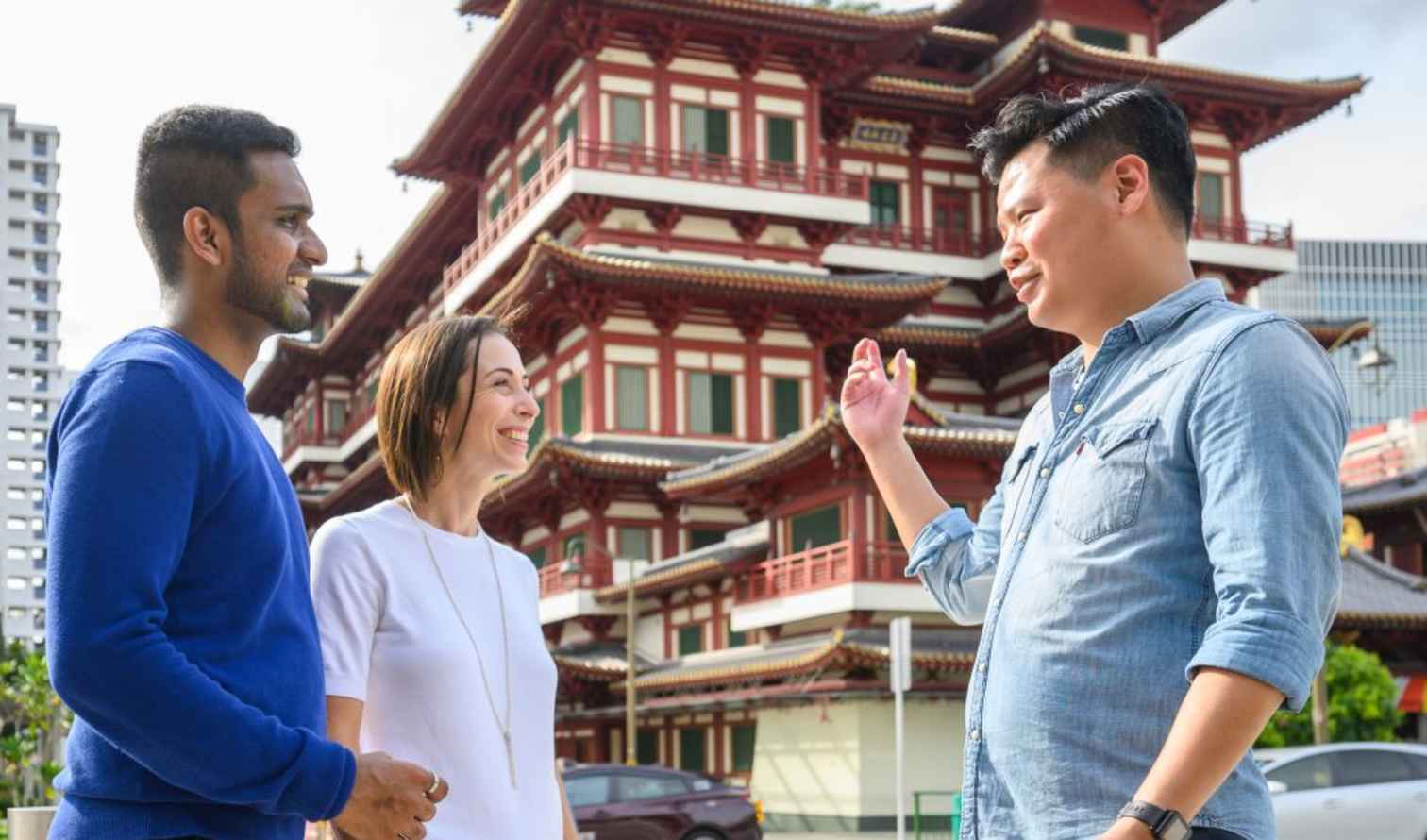 People standing in front of the Buddha Tooth Relic Temple in Singapore.