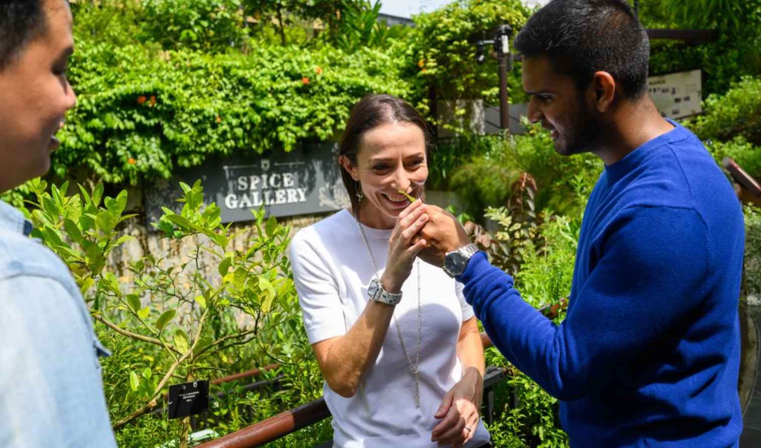 People interacting at the Spice Gallery in a lush garden setting in Singapore