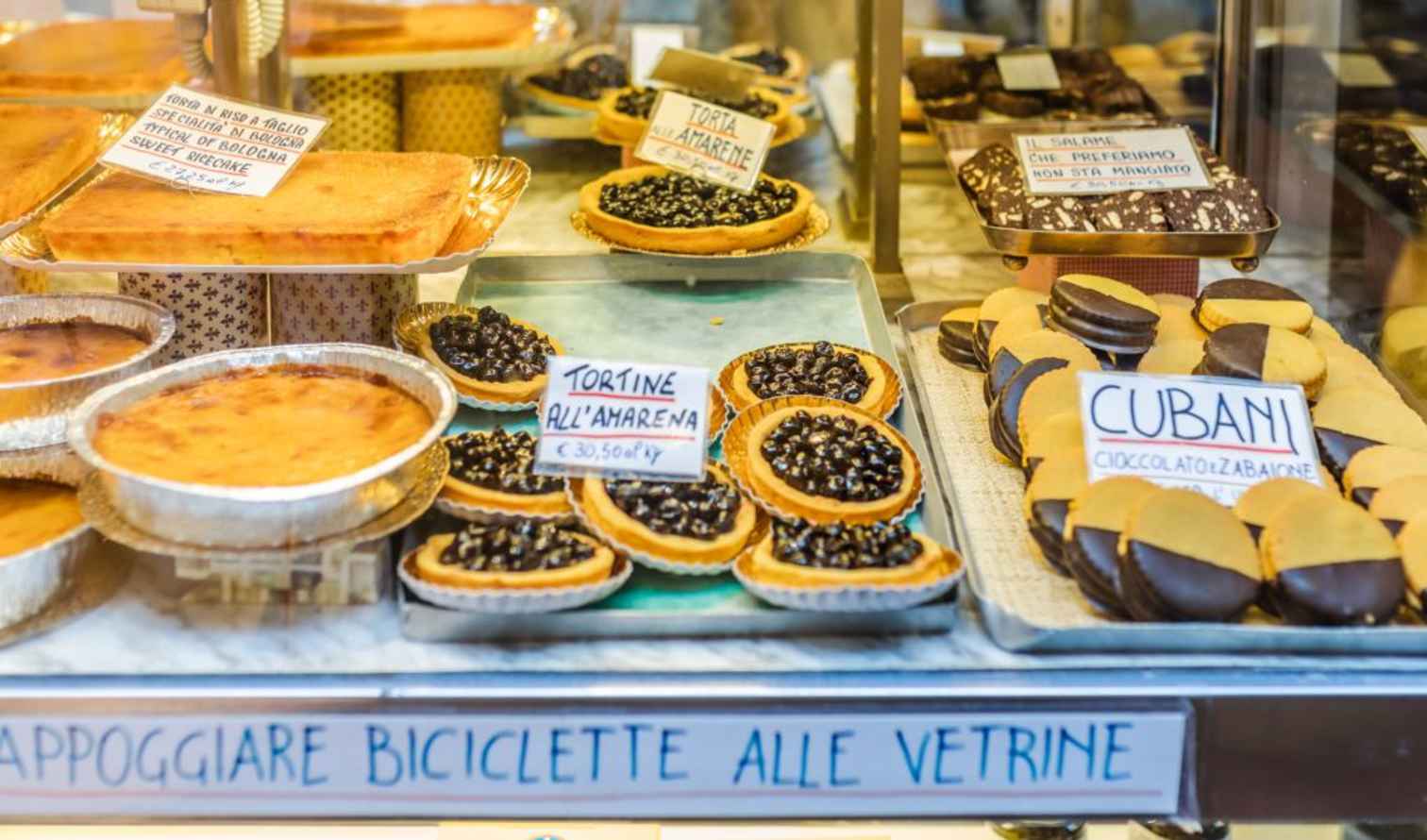 Display of baked goods in an Italian bakery window in Bologna