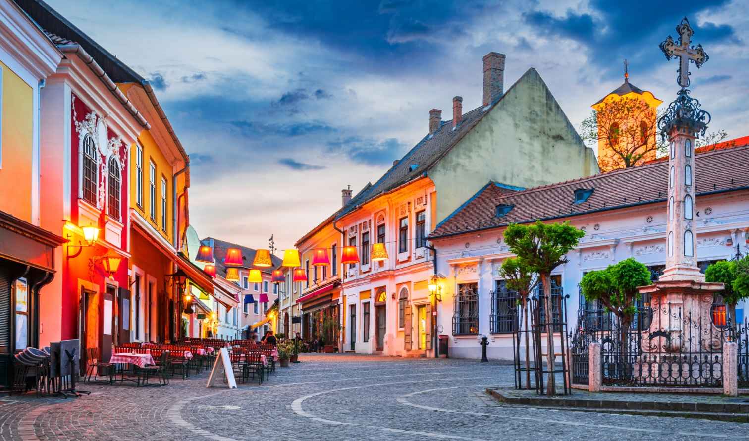 Colorful buildings lining a cobblestone street in Szentendre, Hungary.