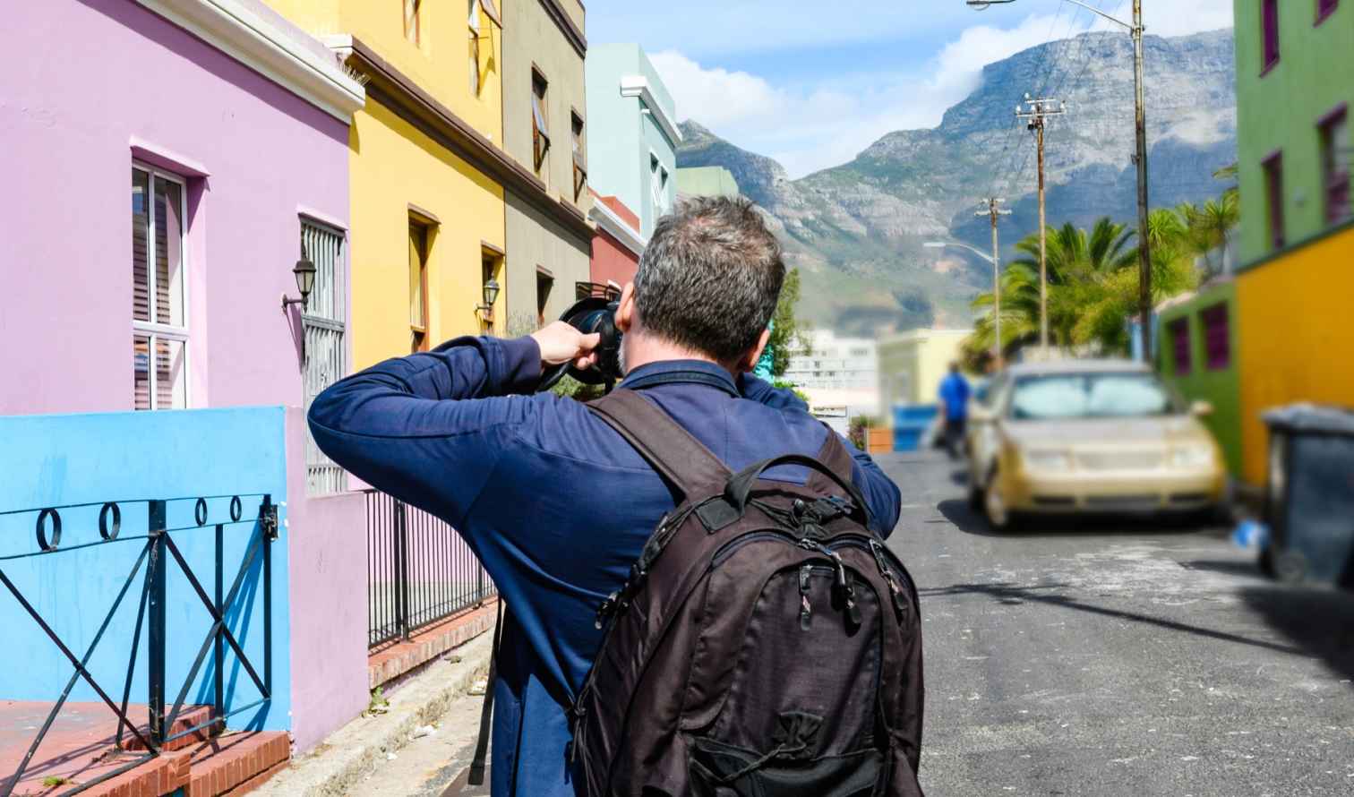 Photographer capturing colorful buildings in Bo-Kaap, Cape Town.