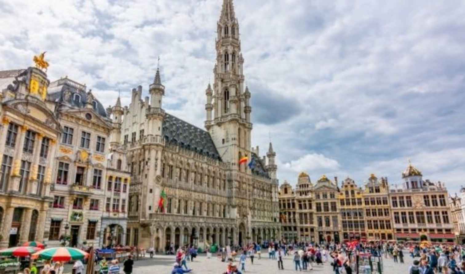 Grand Place in Brussels with people walking around.