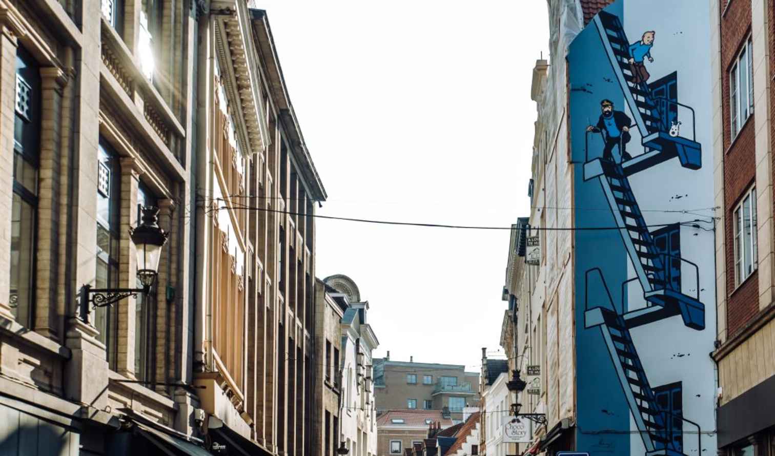 Street view with Tintin mural on Rue de l'Étuve in Brussels.