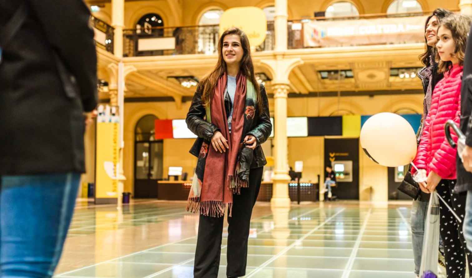 Group of people on a glass floor in a spacious hall in Bologna