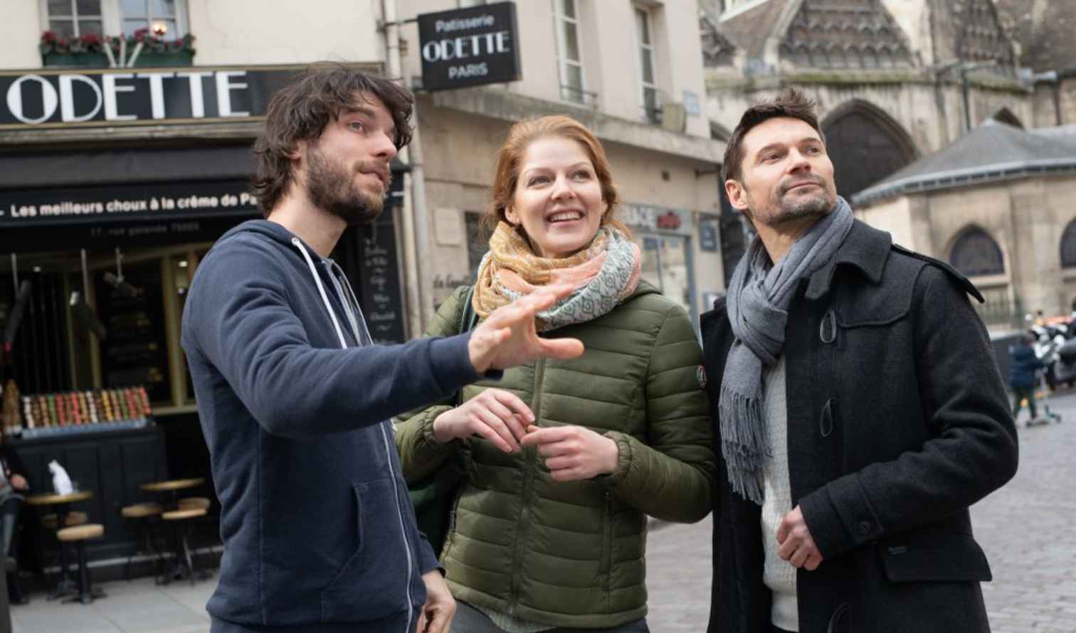 Group of three people outside Odette cafe in Paris.