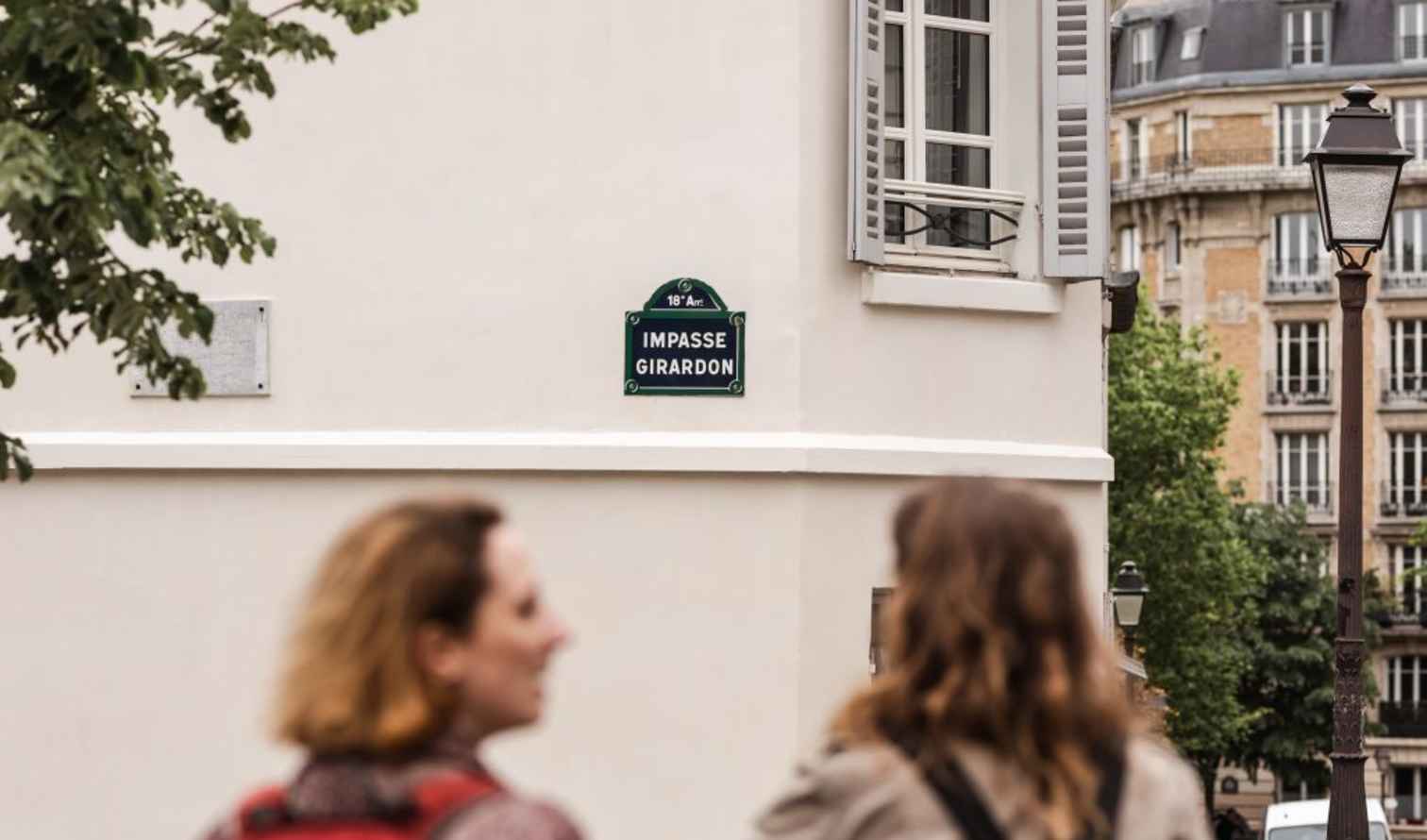 Impasse Girardon street sign on a building corner in Montmartre, Paris.