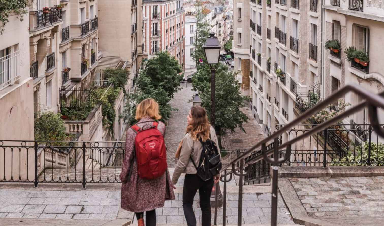 Two women walking down the stairs on Rue Foyatier in Montmartre, Paris.