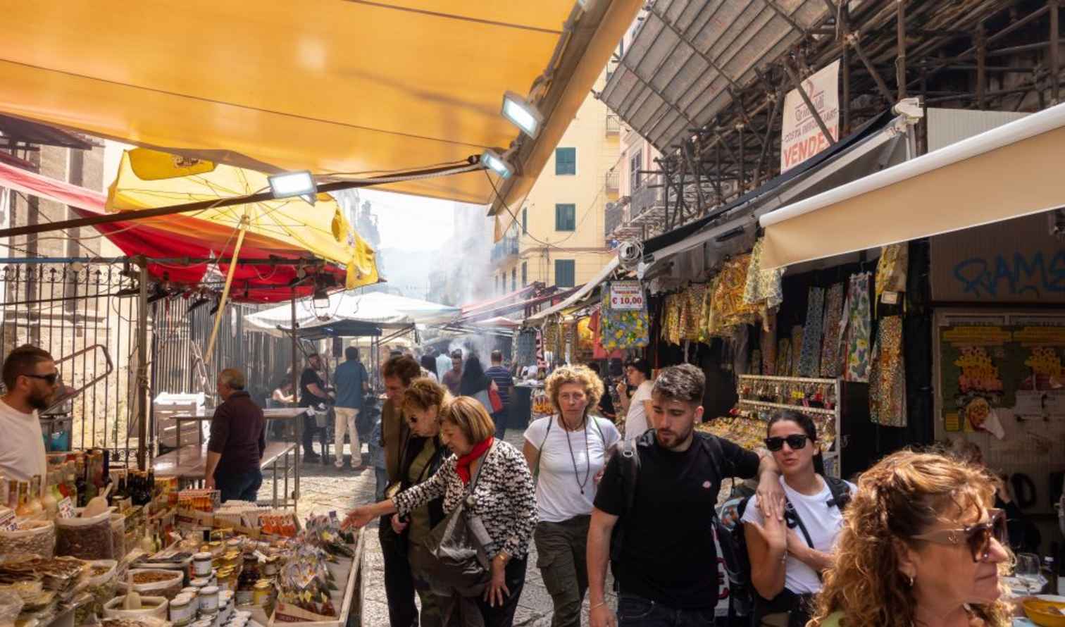 People browsing stalls at Ballarò Market in Palermo, Italy.