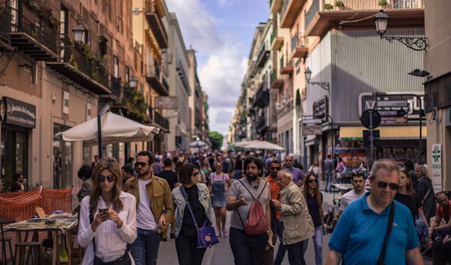 People walk along Via Maqueda in Palermo, Sicily, on a sunny day.