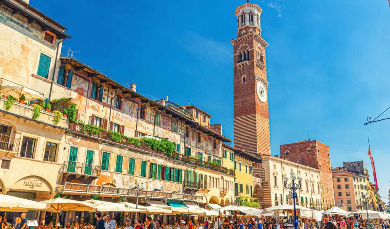Torre dei Lamberti tower in Verona surrounded by historical buildings.