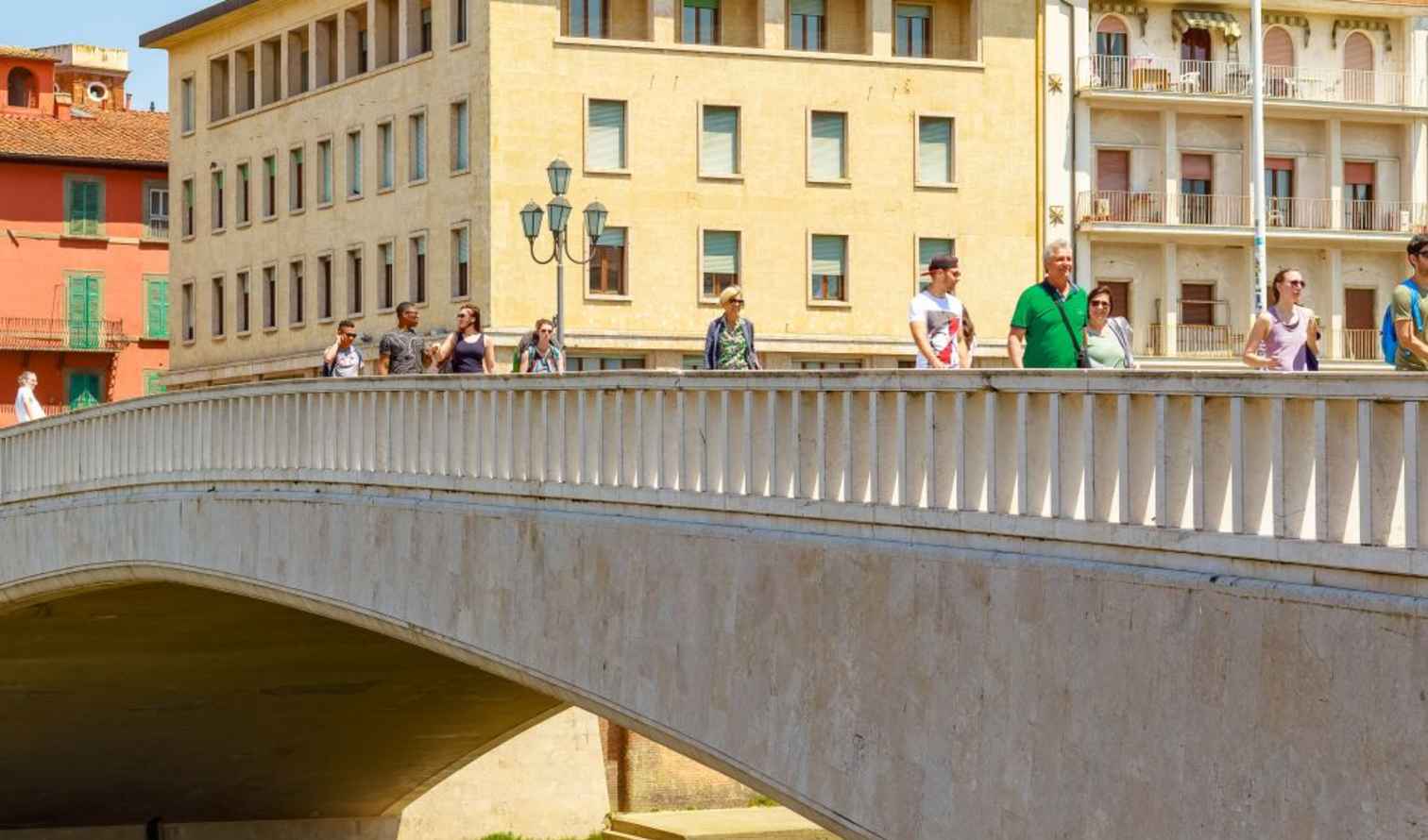 People walking on the Ponte di Mezzo bridge in Pisa, Italy.
