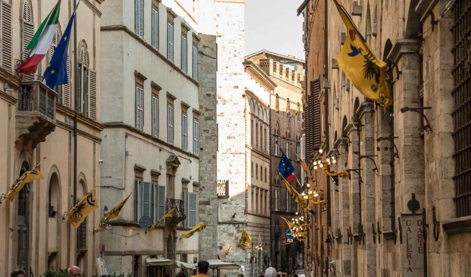 Italian and European Union flags on a building in Siena.