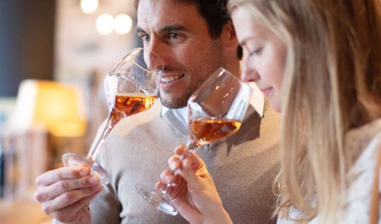 Two people tasting wine at an indoor venue in Palermo