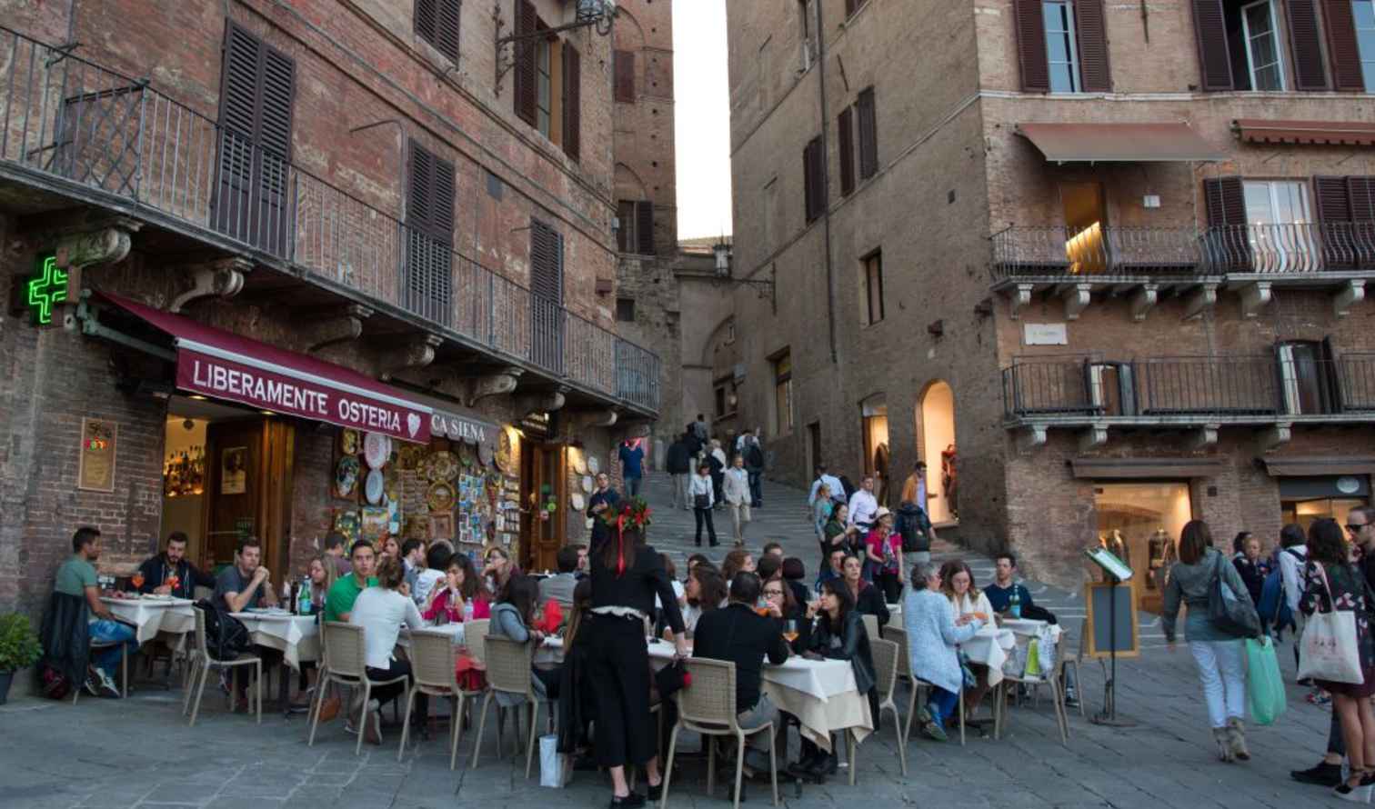 People dining outside Liberamente Osteria in Siena, Italy.