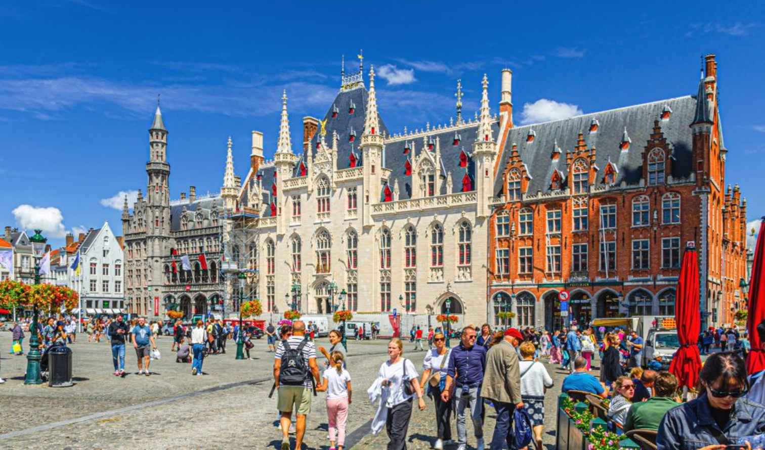 Crowd in front of historical buildings in Bruges, Belgium.