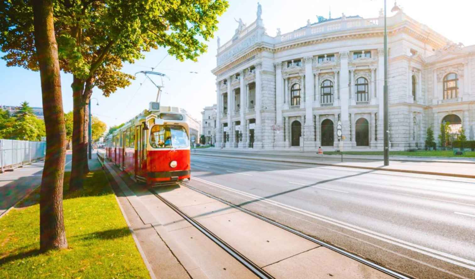 Red tram passing by the Burgtheater in Vienna, Austria.