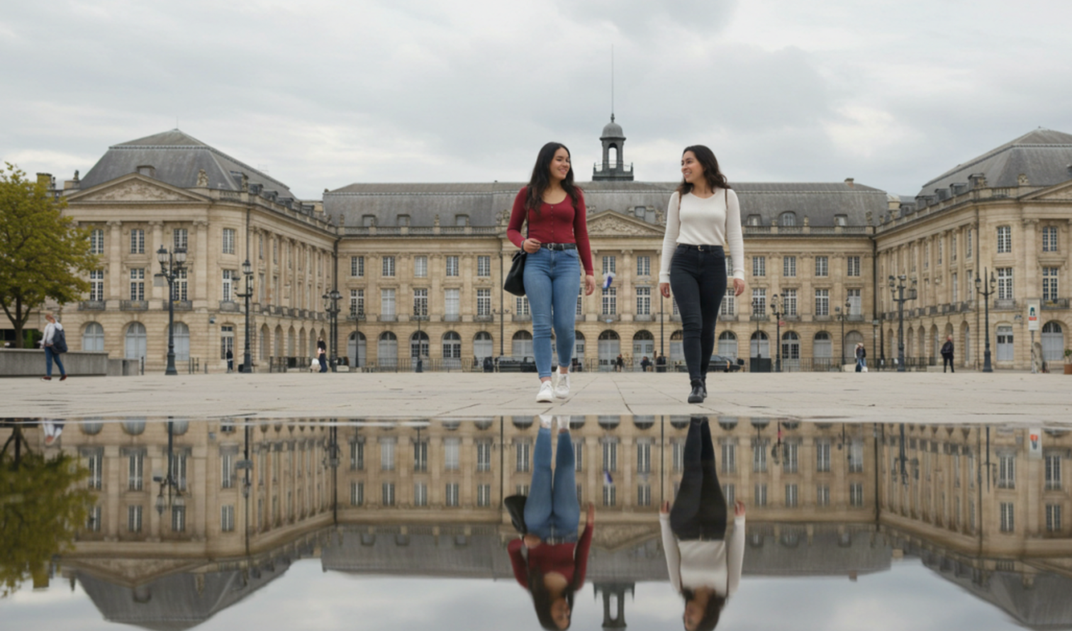 Two women walking in front of Place de la Bourse in Bordeaux.