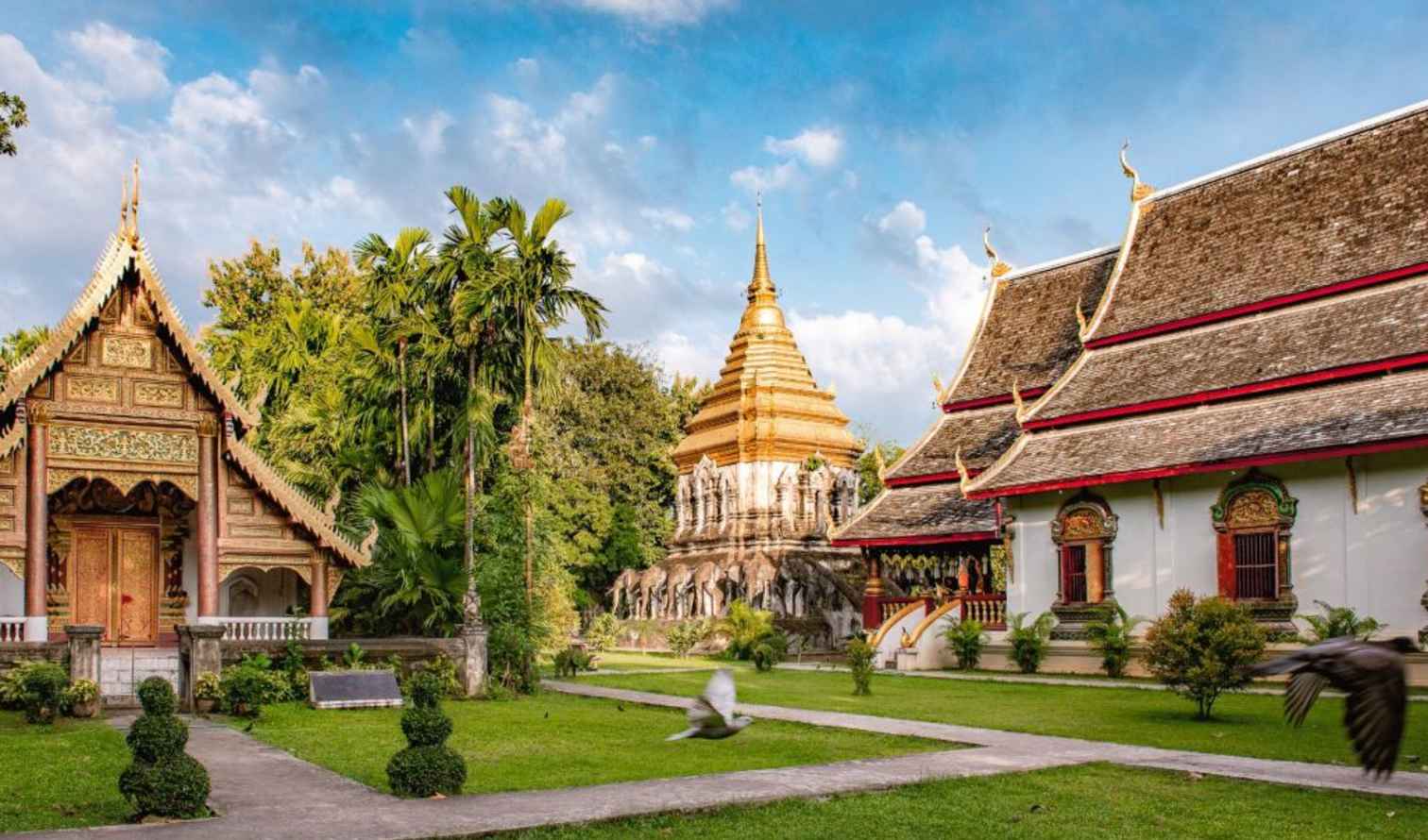 Wat Chiang Man temple complex in Chiang Mai, Thailand features traditional architecture and gardens.