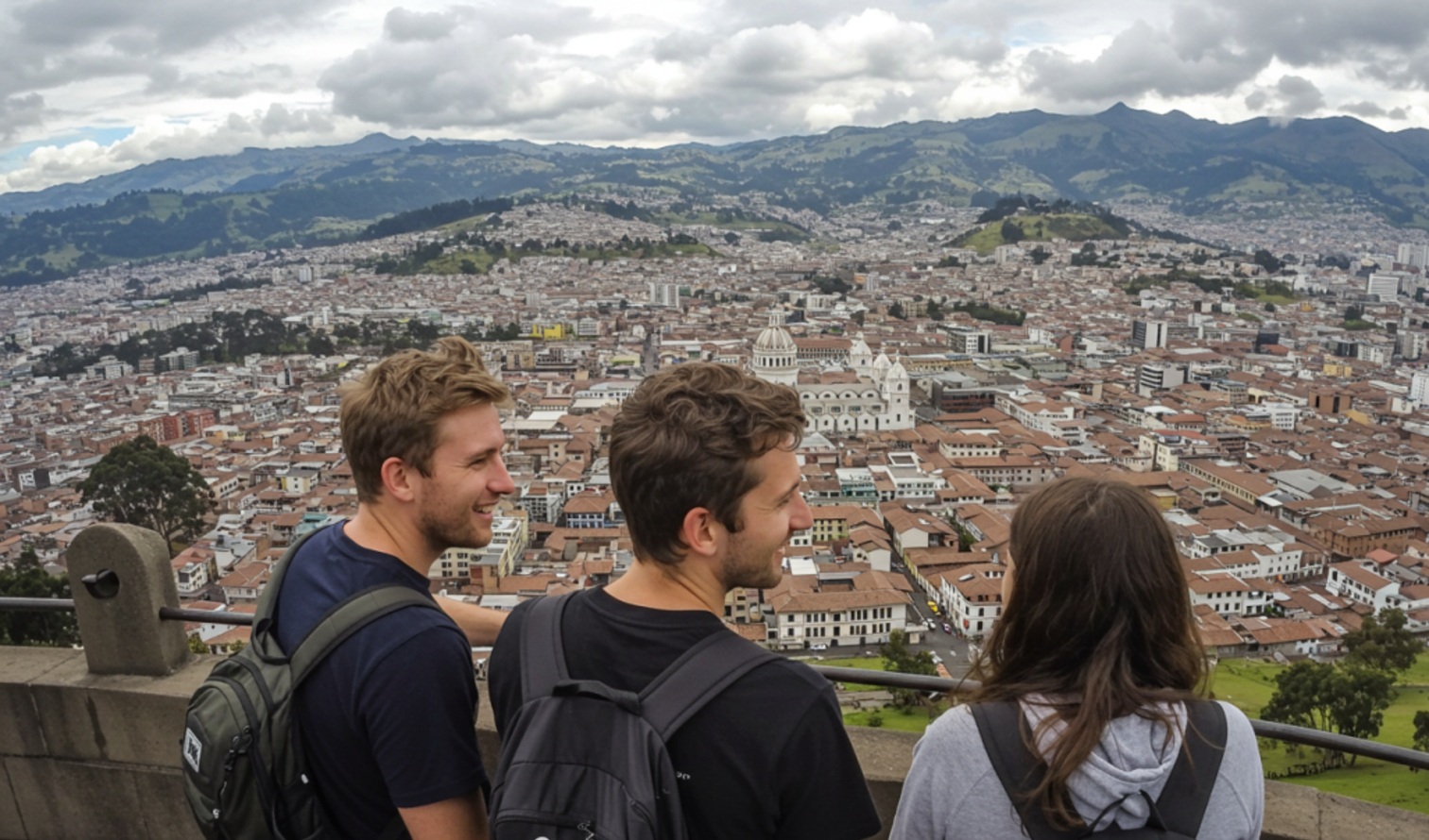 Three people overlooking the cityscape of Quito, Ecuador from a high viewpoint.