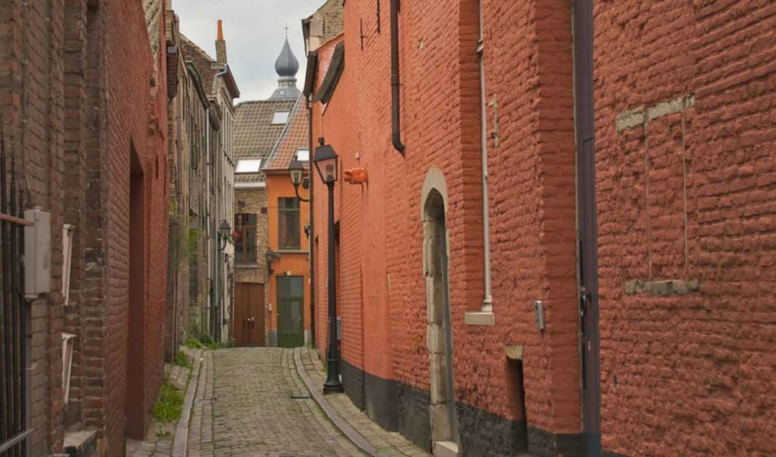 Narrow alley with red brick buildings in Ghent