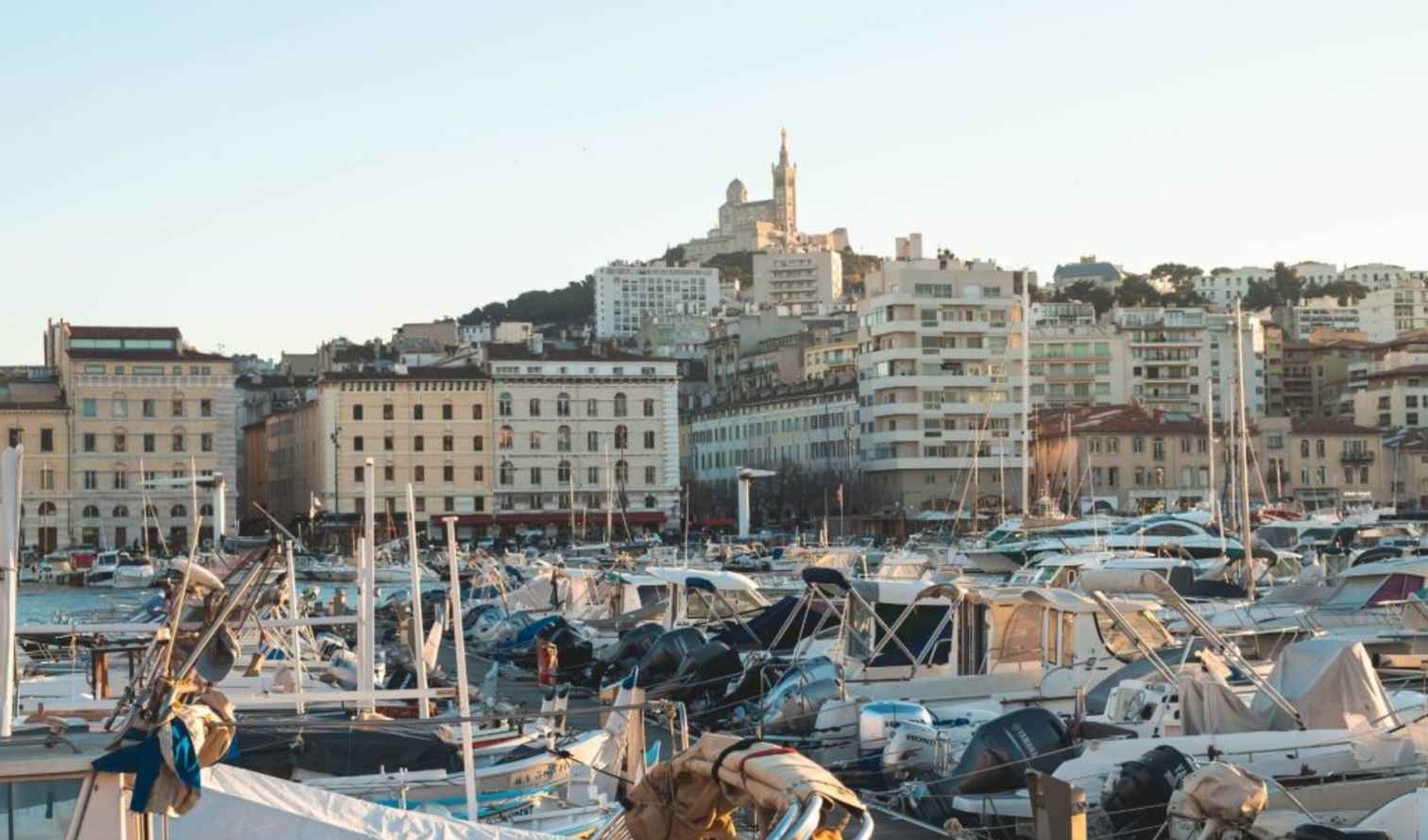 Boats docked in the Old Port of Marseille with buildings in the background.