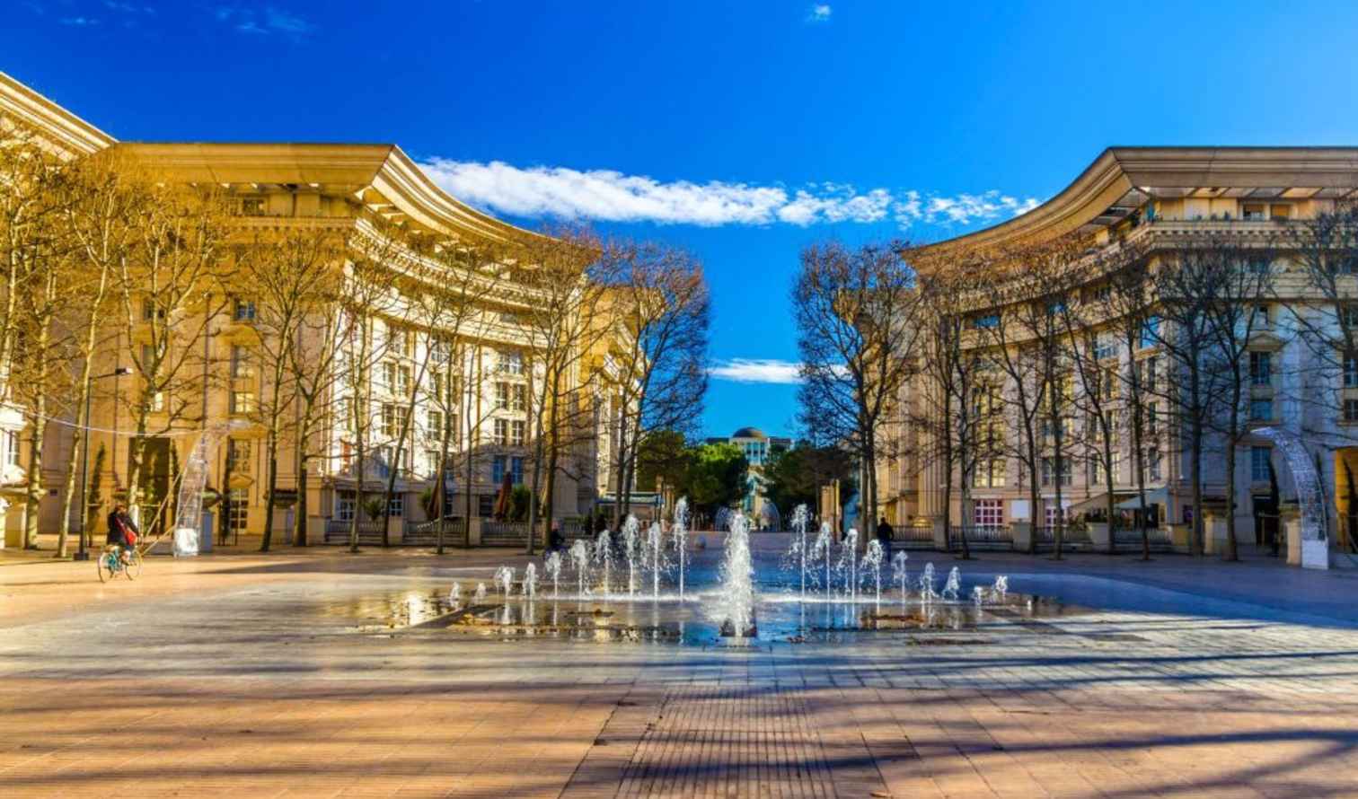 Antigone district plaza in Montpellier with symmetrical buildings and water fountain.