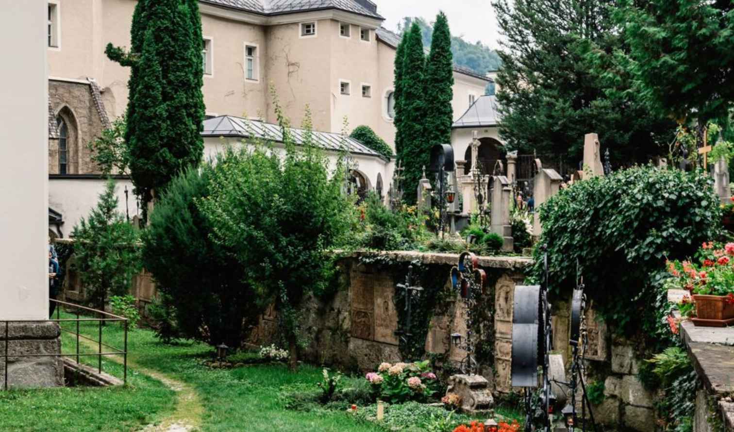 Tombstones and lush vegetation in St. Peter's Cemetery, Salzburg.