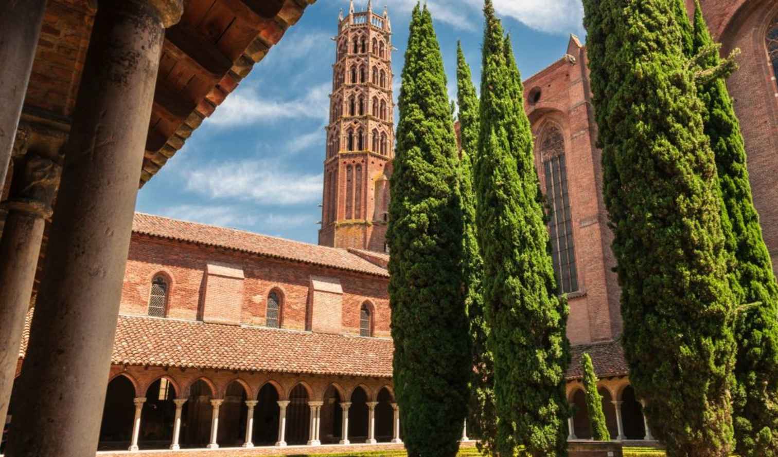 Cloister courtyard with tall cypress trees at the Church of the Jacobins, Toulouse.