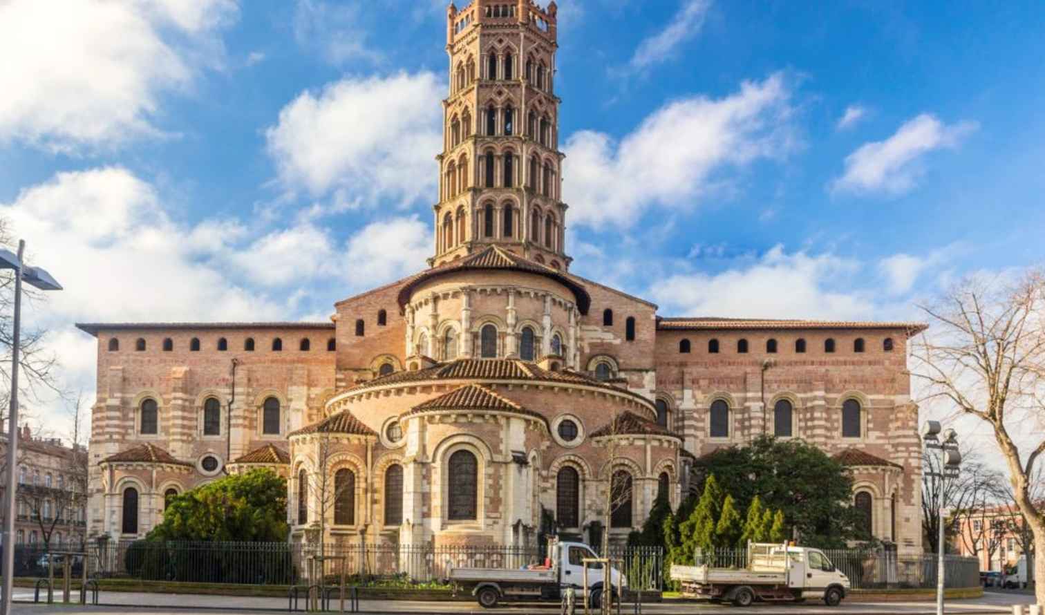 Basilica of Saint-Sernin in Toulouse, France, with a clear blue sky.
