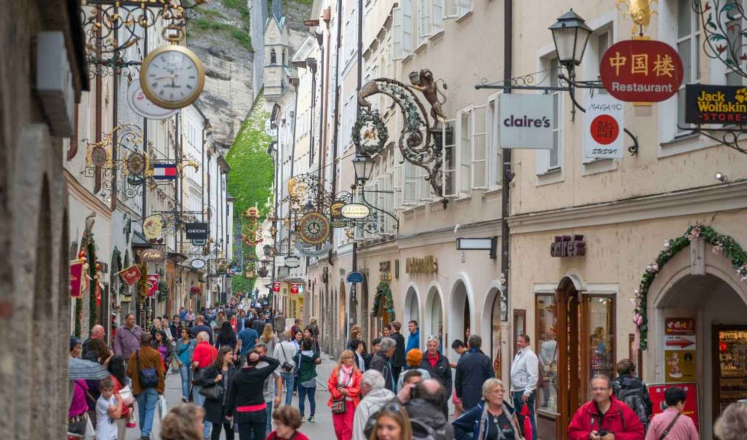Crowded pedestrians on Getreidegasse street in Salzburg, Austria.