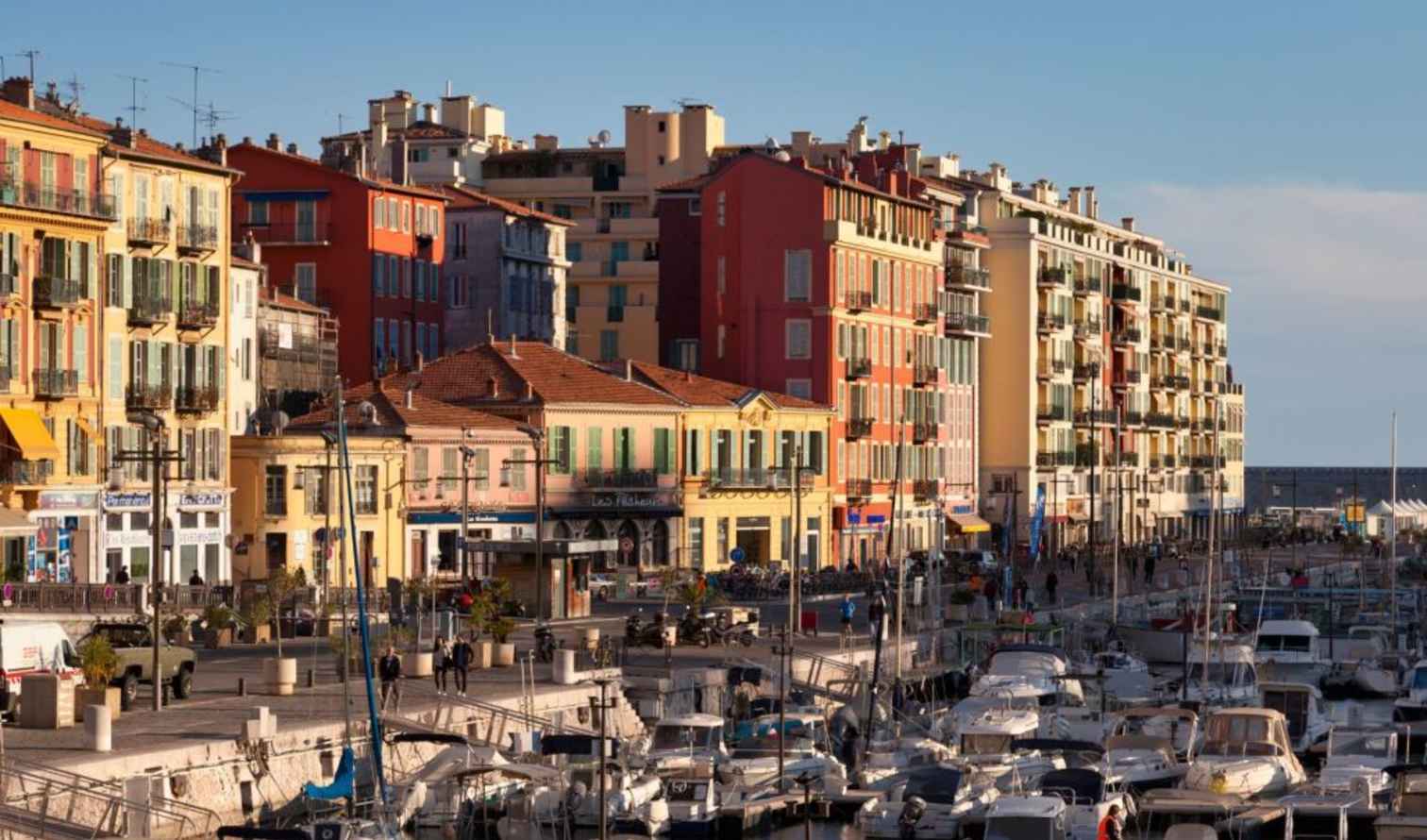 Port of Nice with colorful buildings and moored boats in Nice