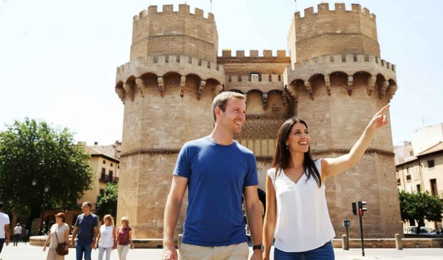 People walking near the Torres de Serranos in Valencia.