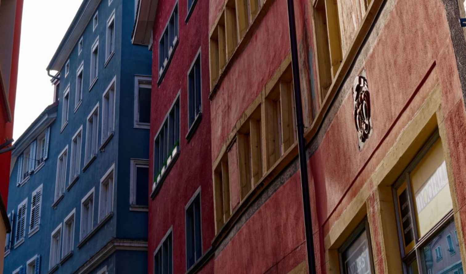Colorful buildings on a narrow street in Zurich's Old Town.