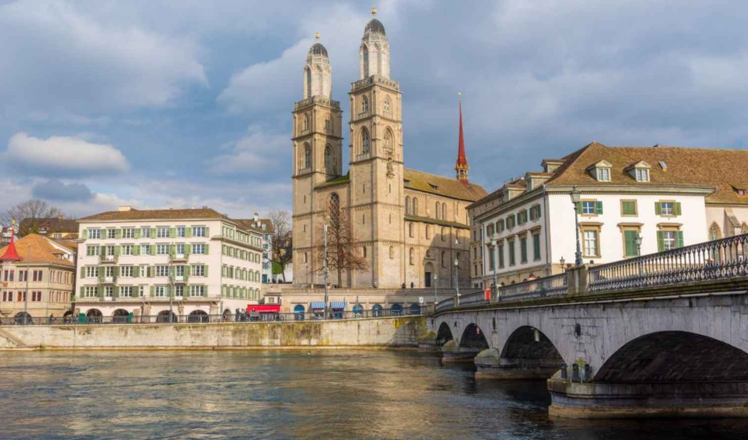View of Grossmünster church next to the Limmat River in Zurich, Switzerland.