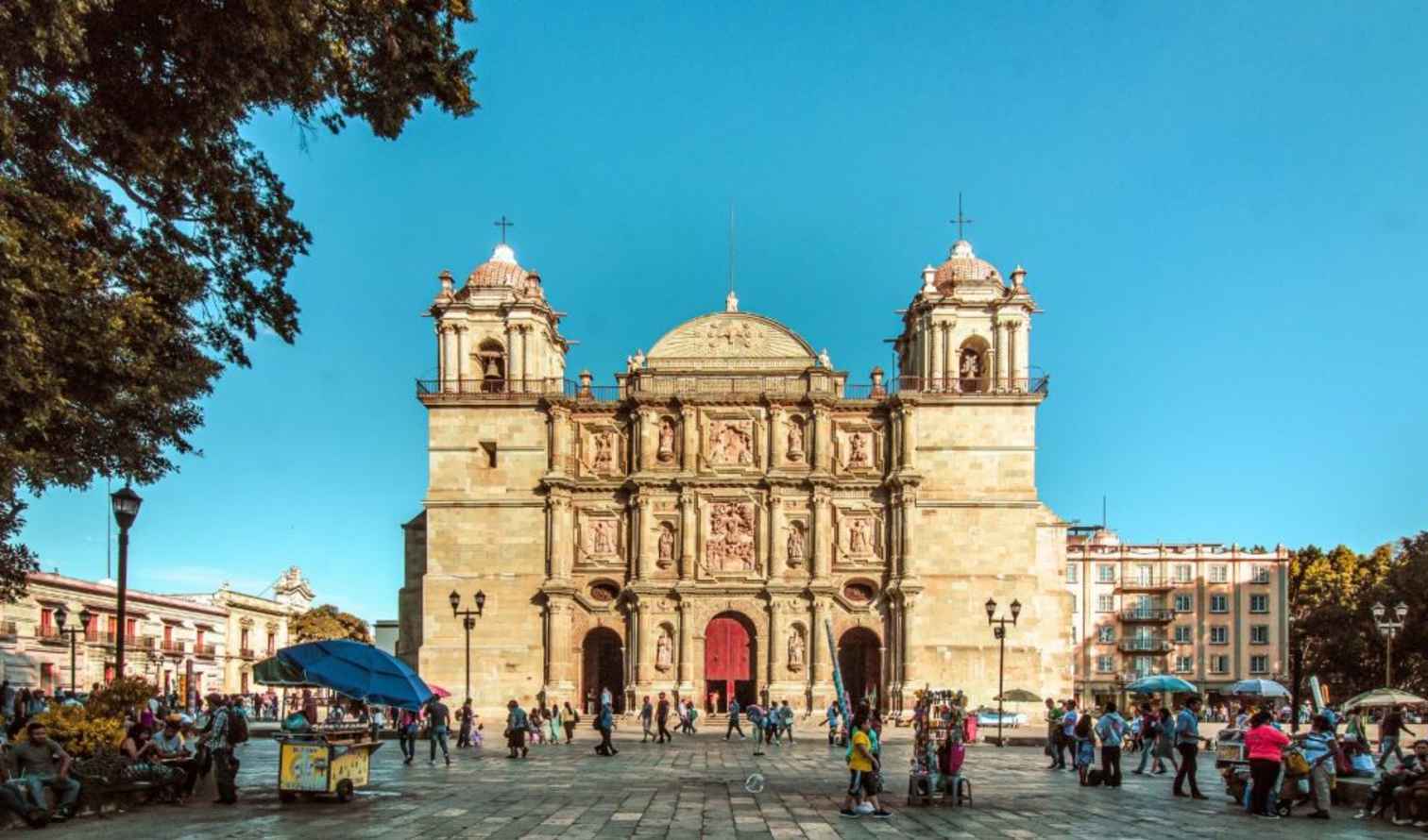 People walking in front of the Oaxaca Cathedral in Mexico.